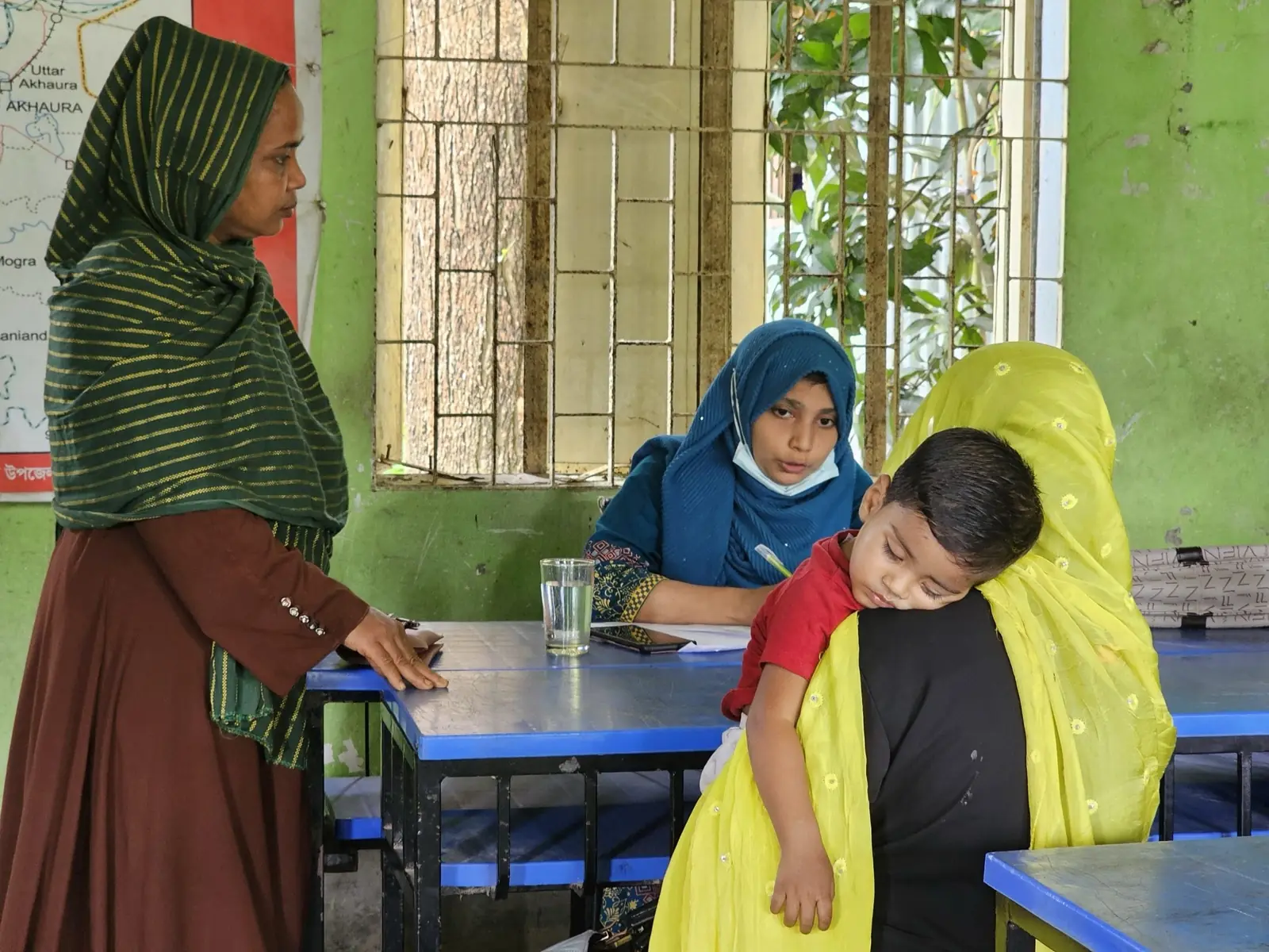 A mother comforts her son during a consultation at the free Friday clinic in Baishmouja
