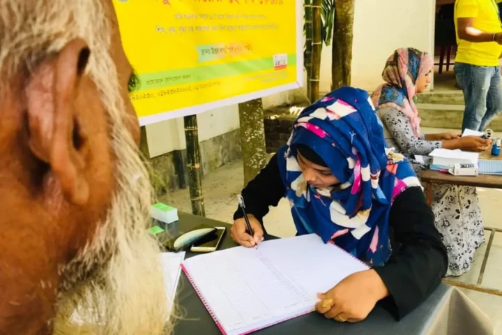 A volunteer records the details of a goat handed over under the AKWO self-reliance program