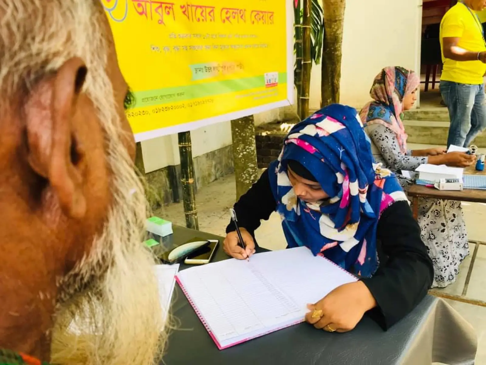 A volunteer records the details of a goat handed over under the AKWO self-reliance program